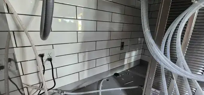 Circuits roughed in behind the counter wall before finishes went on.